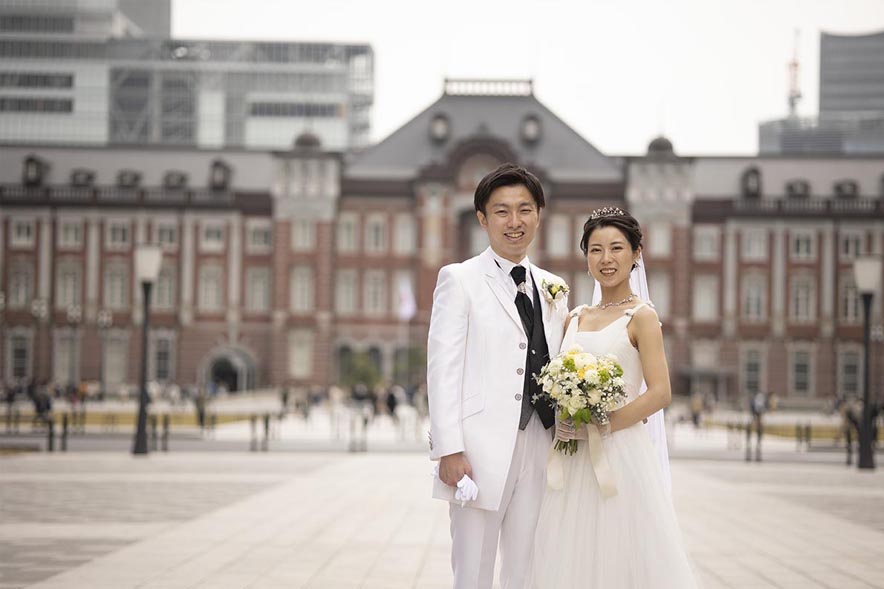 花束を手に繋ぐ新郎新婦